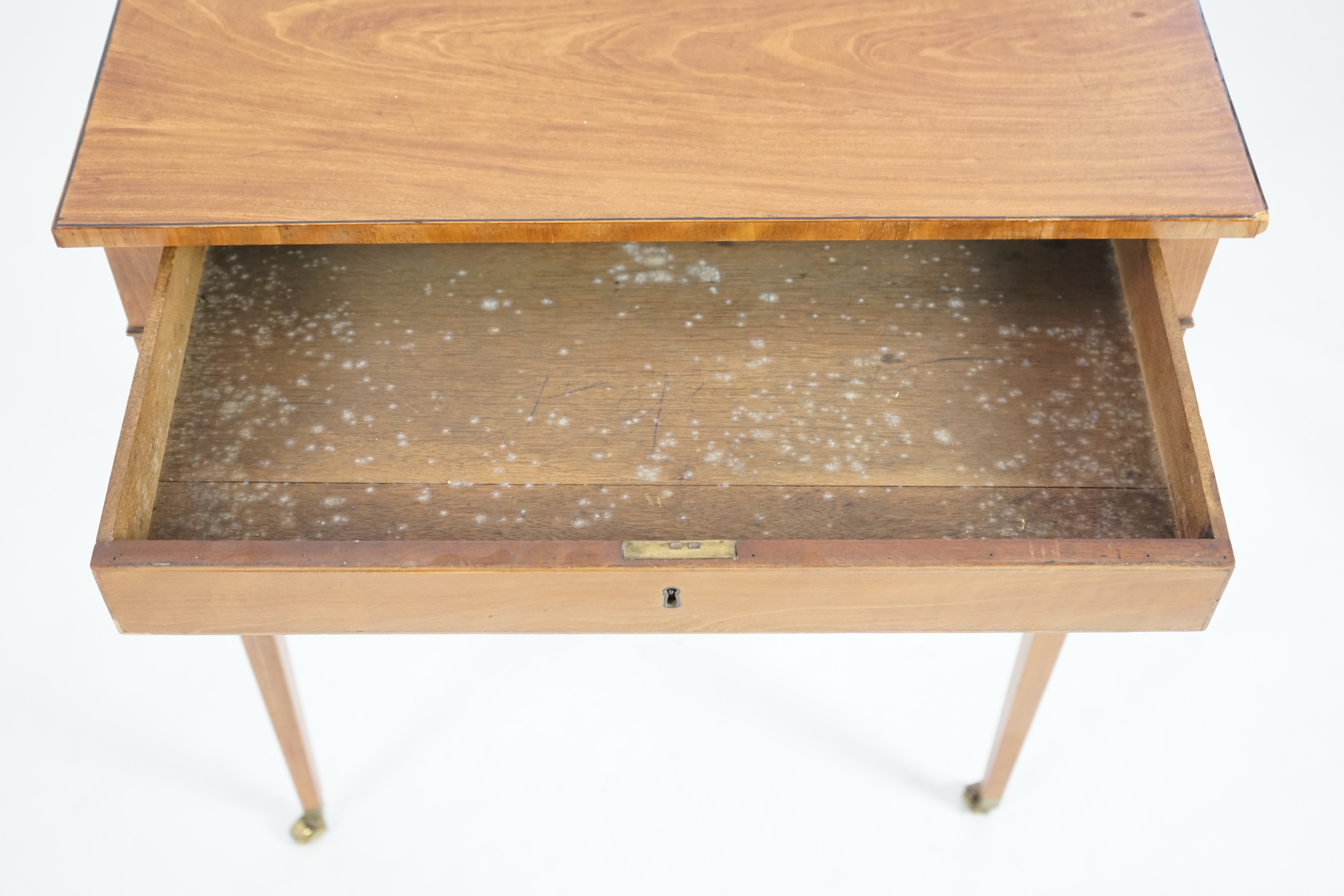 An Edwardian satinwood occasional table, with rectangular top and frieze drawer, on square tapered legs, fitted brass castors, 62cm wide, 37cm deep, 71cm high. Condition - of good rich colour, some old scuffs and scratch
